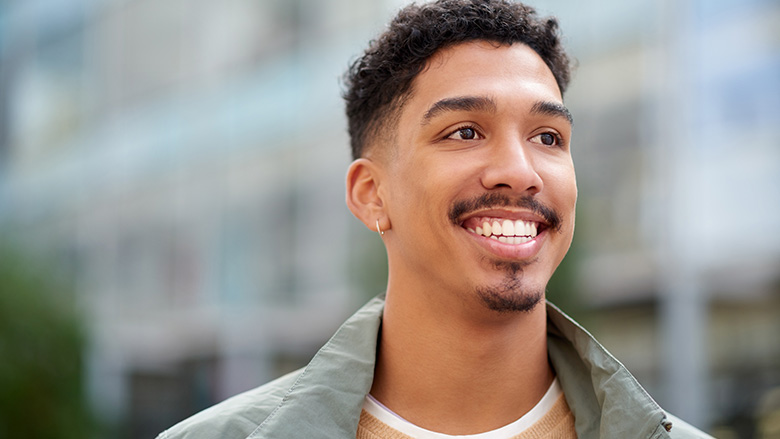 Man smiling and looking off screen