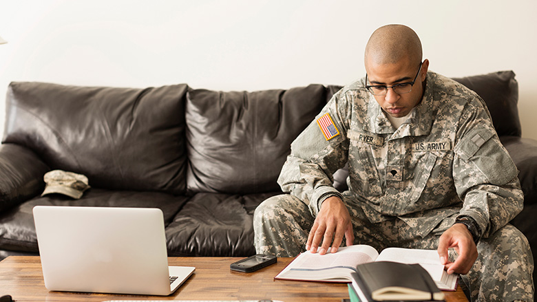 Man in military uniform reading a book